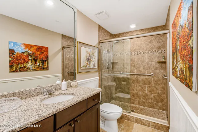 a living room with a couch and painting on the wall