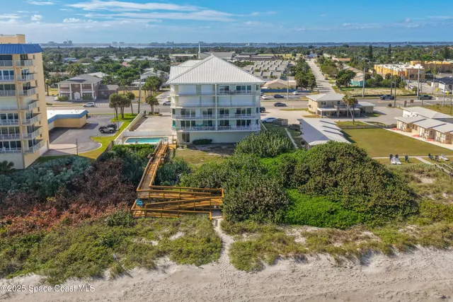 a view of a house with a deck and a yard