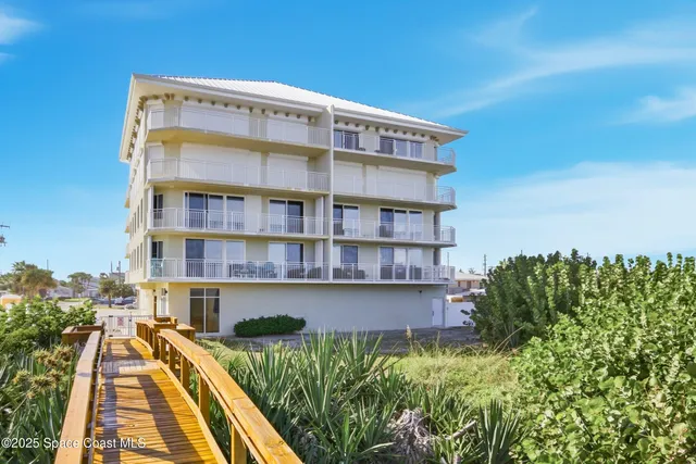 a view of a chairs and table in the balcony
