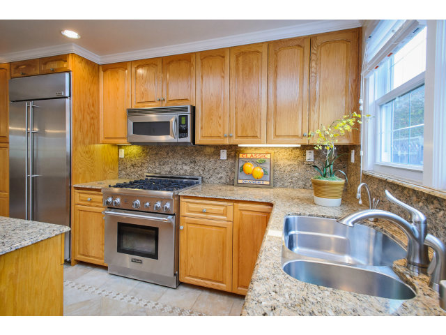 512 Princeton Road San Mateo, CA 94402 - Photo 7 of 13 a kitchen with stainless steel appliances granite countertop a sink stove and refrigerator