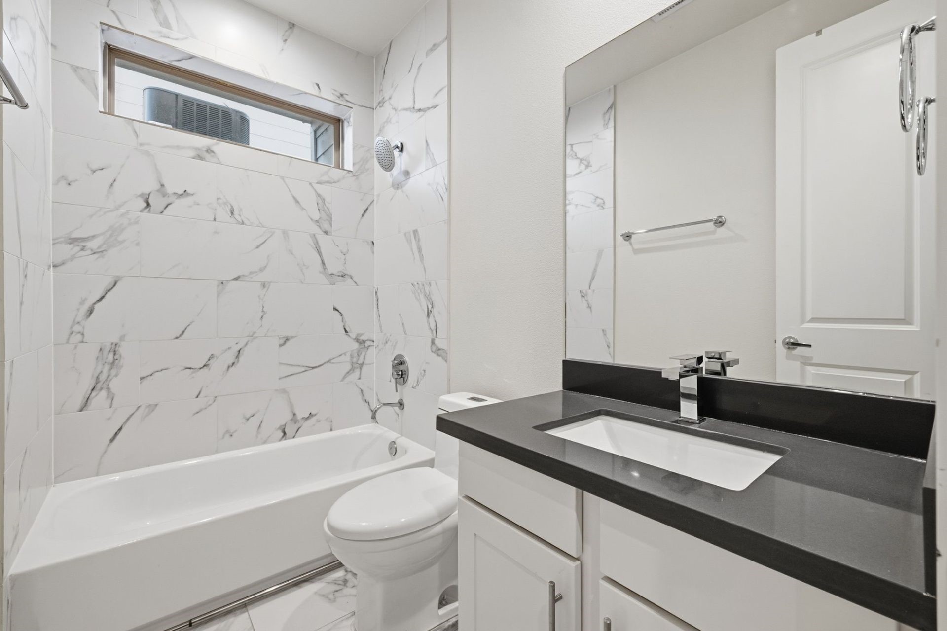 2948 Alice Street Houston, TX 77054 - Photo 18 of 24 a bathroom with a granite countertop sink a toilet a mirror a bathtub and shower