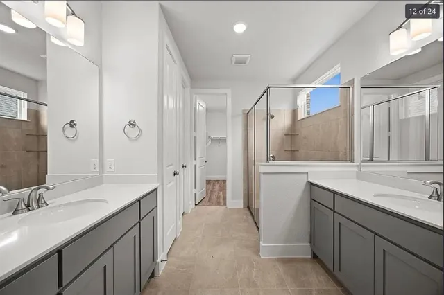 a bathroom with a sink double vanity and a mirror