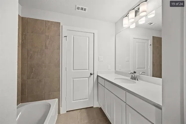 a view of an empty room with wooden floor and closet