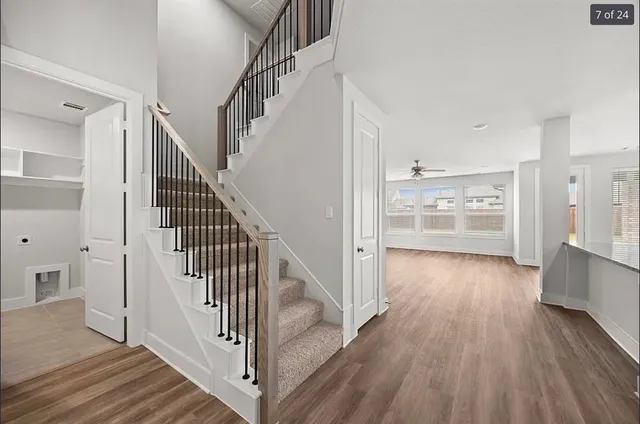 a view of a kitchen with wooden floor and electronic appliances