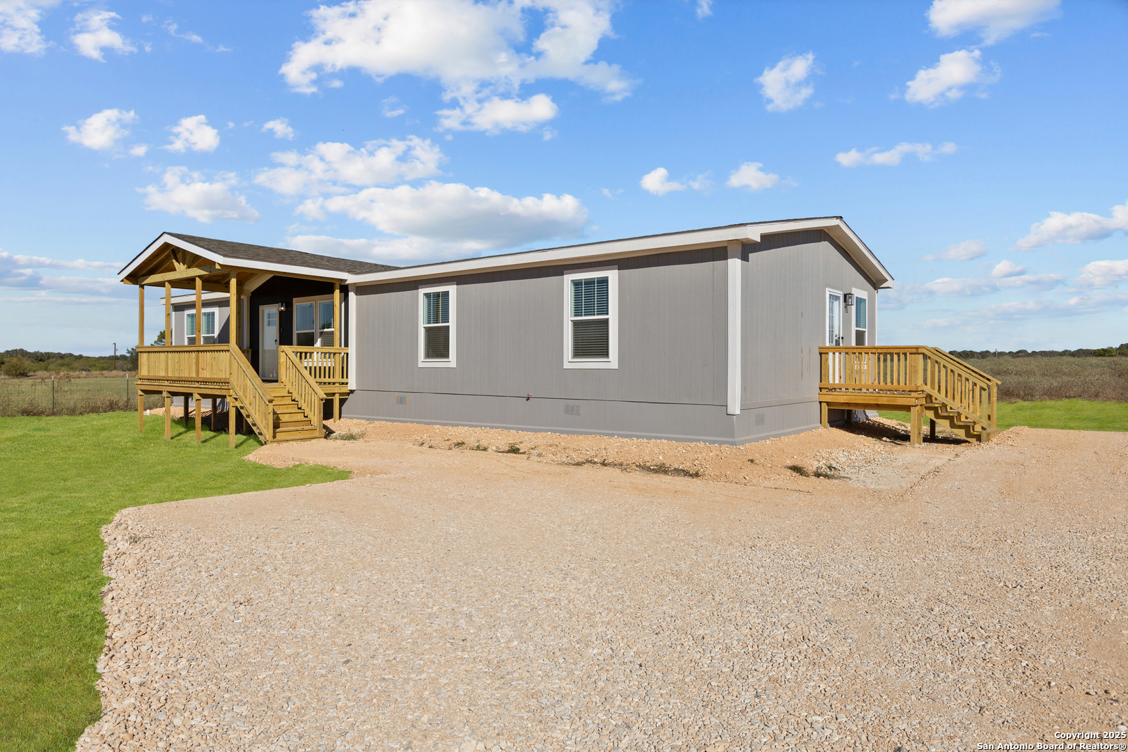 2354 Stevens Road Somerset, TX 78069 - Photo 2 of 22 a front view of a house with a yard and garage
