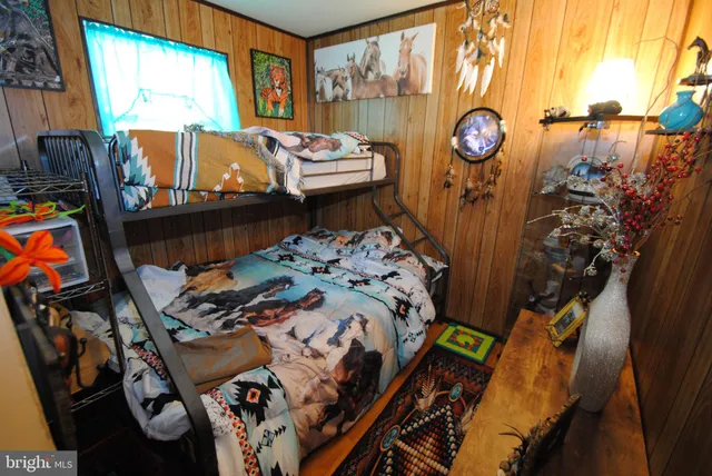 a view of balcony with wooden floor outdoor seating and yard in the back