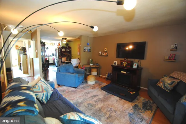a living room with furniture a rug and a chandelier