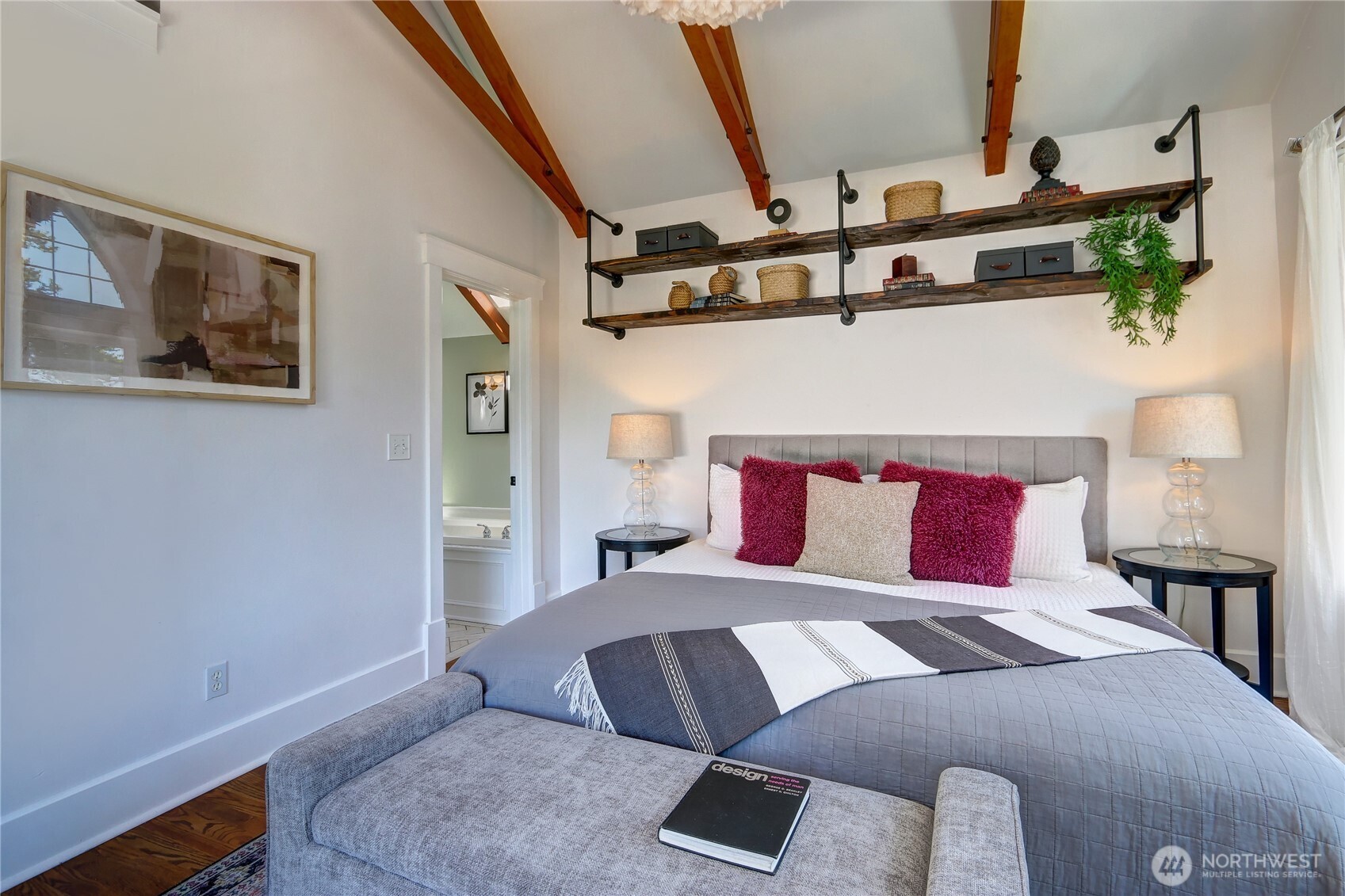 9510 9th Avenue Northwest Seattle, WA 98117 - Photo 16 of 31 a bedroom with a large bed and a chandelier