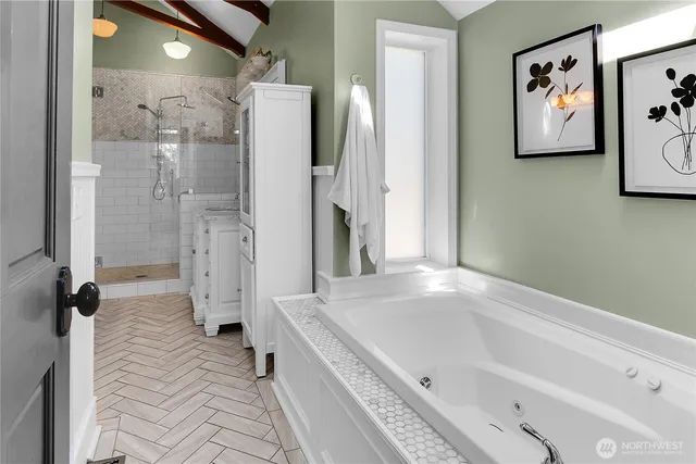 a bathroom with a tub and a shower