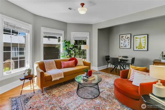 a living room with furniture and a potted plant