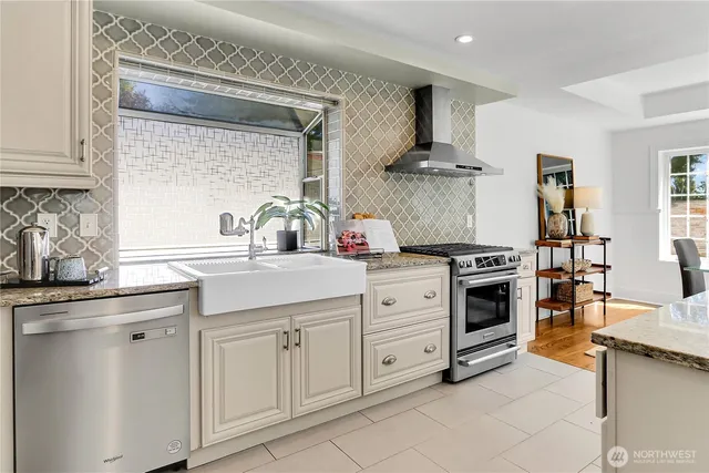 a kitchen with white cabinets and appliances