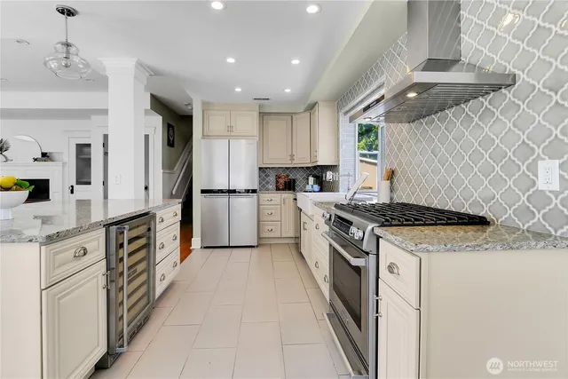 a kitchen with stainless steel appliances granite countertop a stove and a refrigerator
