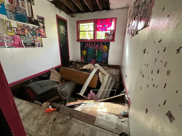 a view of a living room with furniture and a flat screen tv
