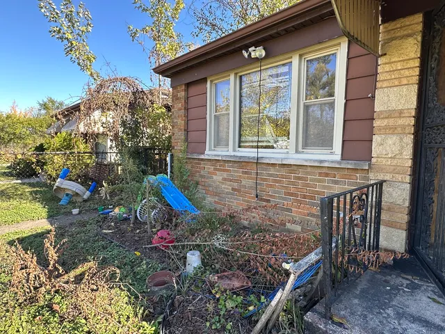 a view of a house with a yard and sitting area