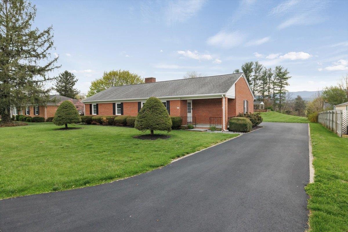 a front view of house with yard and green space