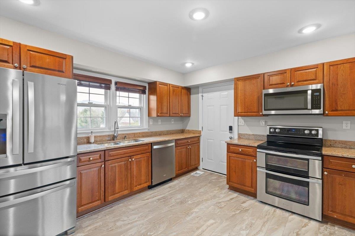 13 Springcrest Drive Luray, VA 22835 - Photo 11 of 41 a large kitchen with stainless steel appliances granite countertop a stove top oven a sink dishwasher a refrigerator and cabinets with wooden floor