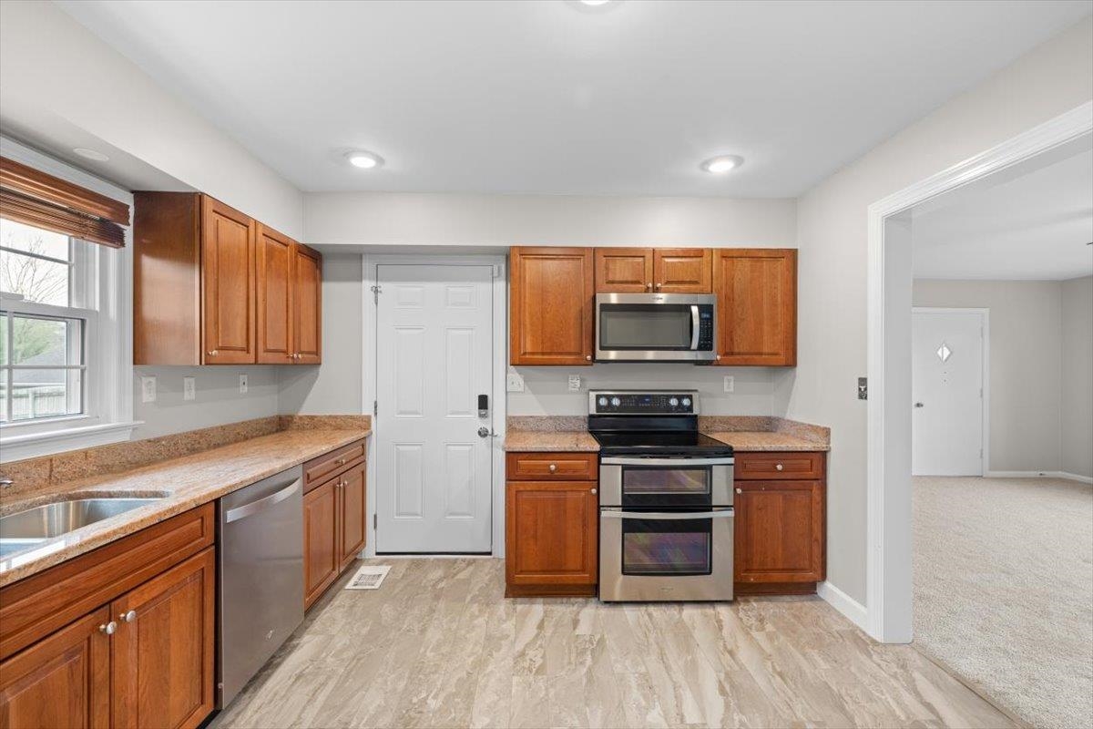 13 Springcrest Drive Luray, VA 22835 - Photo 12 of 41 a kitchen with stainless steel appliances wooden floors and wooden cabinets