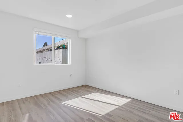 an empty room with painting and furniture