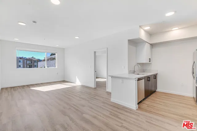 a kitchen with a stove top oven sink and cabinets