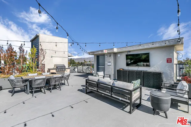 a living room with furniture a fireplace and a table