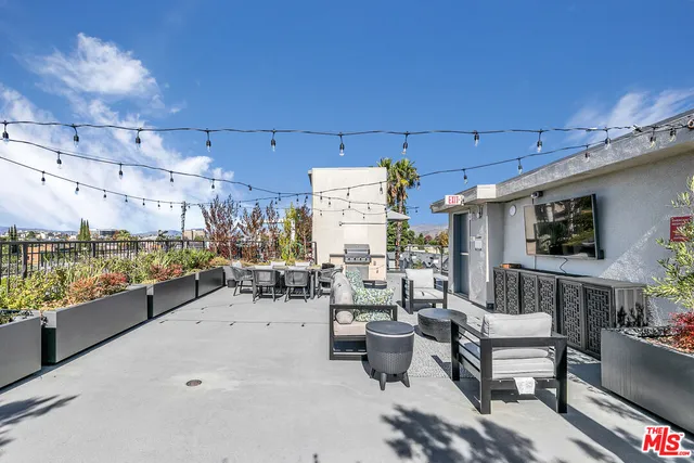 a outdoor space with lots of tables a garden and chairs