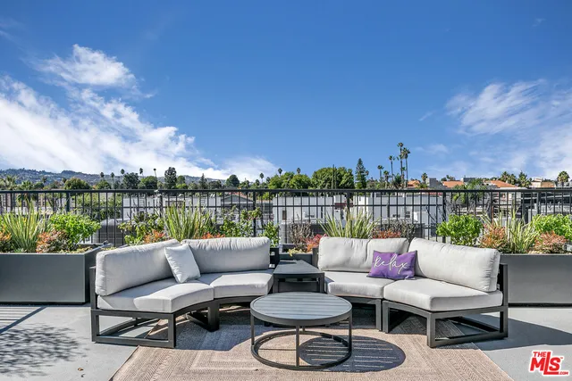 a balcony with furniture and a lake view
