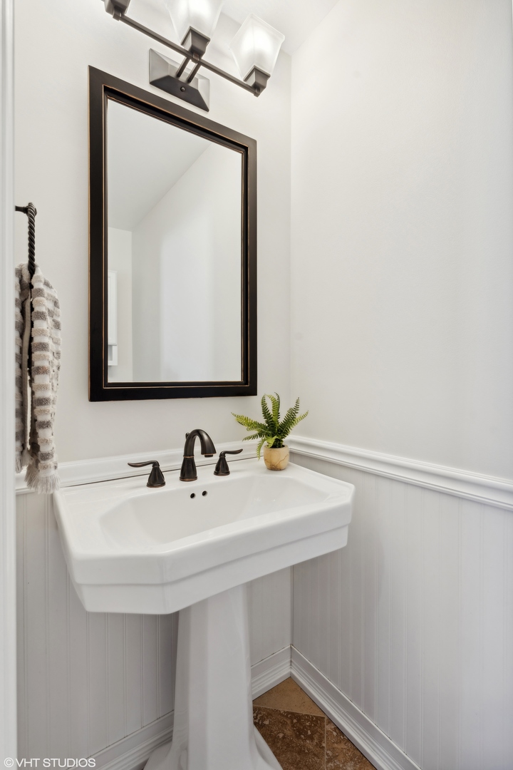 1251 West Fletcher Street, Unit E Chicago, IL 60657 - Photo 17 of 20 a bathroom with a sink and a mirror