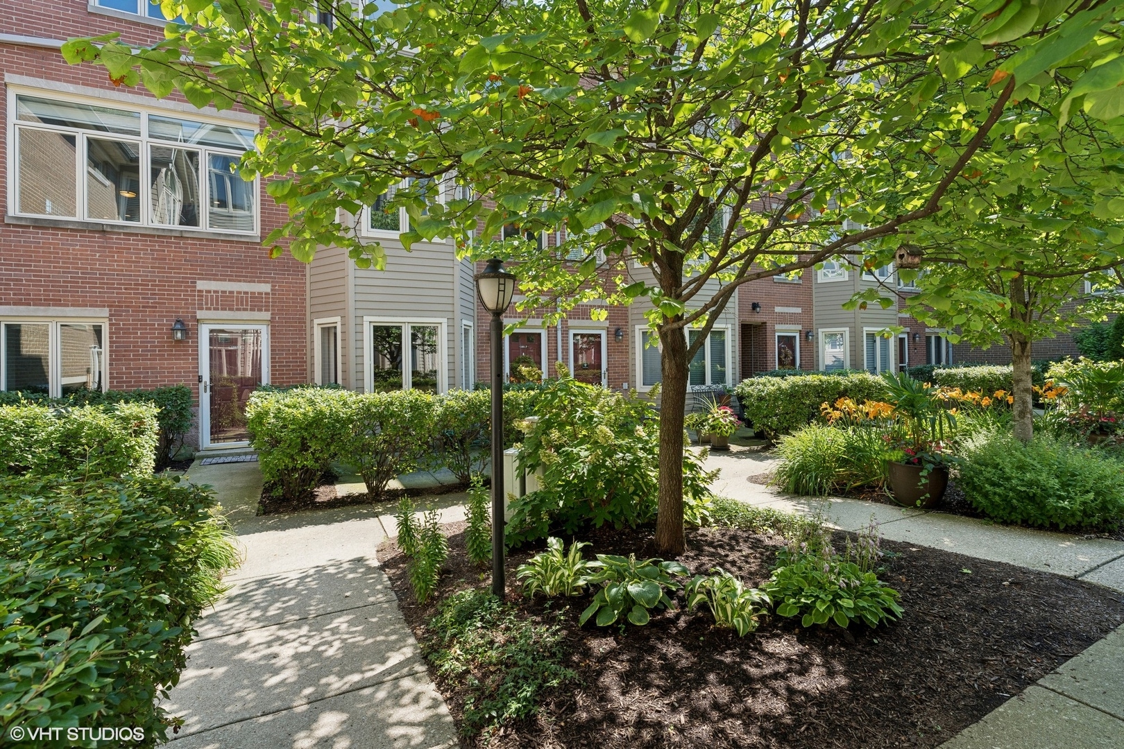 1251 West Fletcher Street, Unit E Chicago, IL 60657 - Photo 20 of 20 a front view of a house with a yard