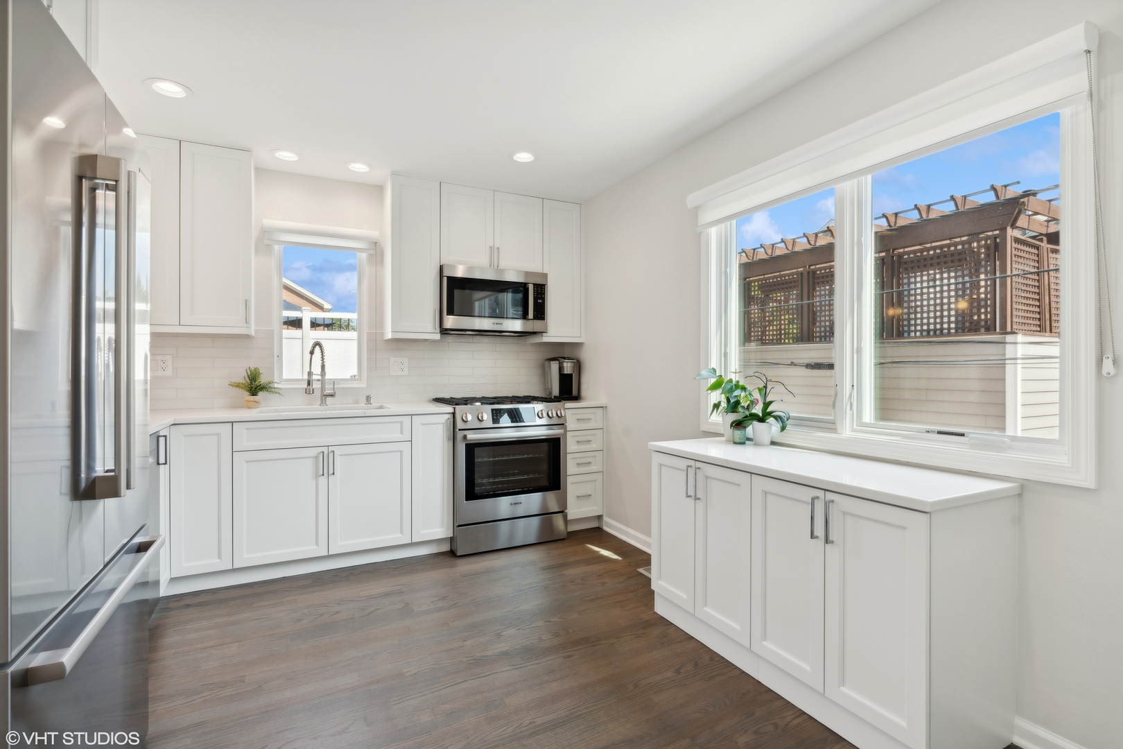 1251 West Fletcher Street, Unit E Chicago, IL 60657 - Photo 7 of 20 a kitchen with white cabinets and appliances