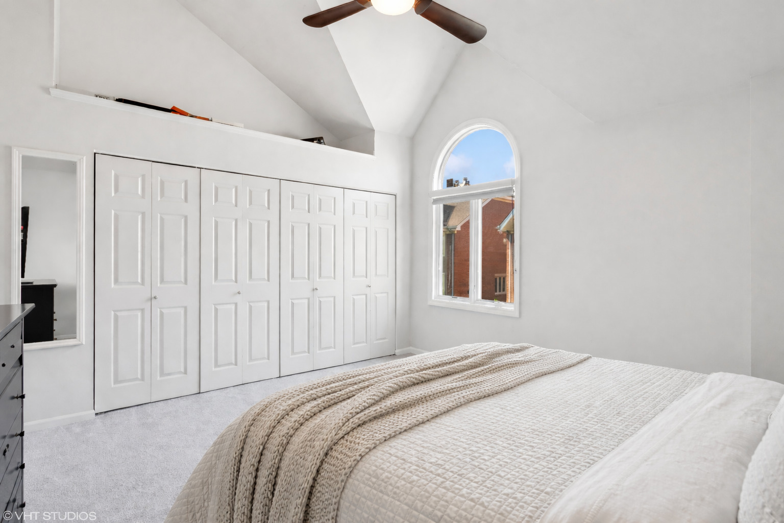 1251 West Fletcher Street, Unit E Chicago, IL 60657 - Photo 9 of 20 a bedroom with a bed and a chandelier