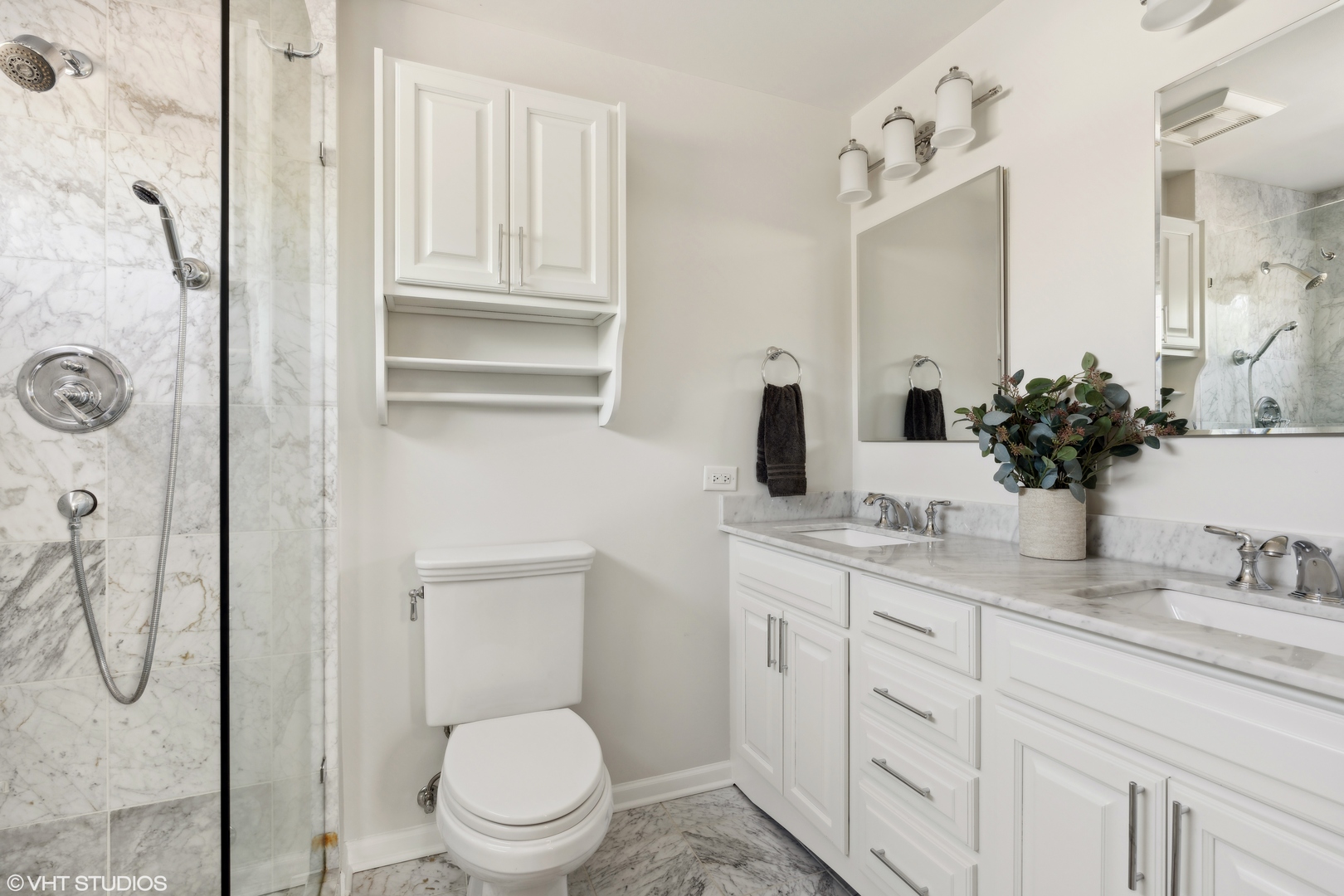 1251 West Fletcher Street, Unit E Chicago, IL 60657 - Photo 10 of 20 a bathroom with a granite countertop sink a toilet and mirror