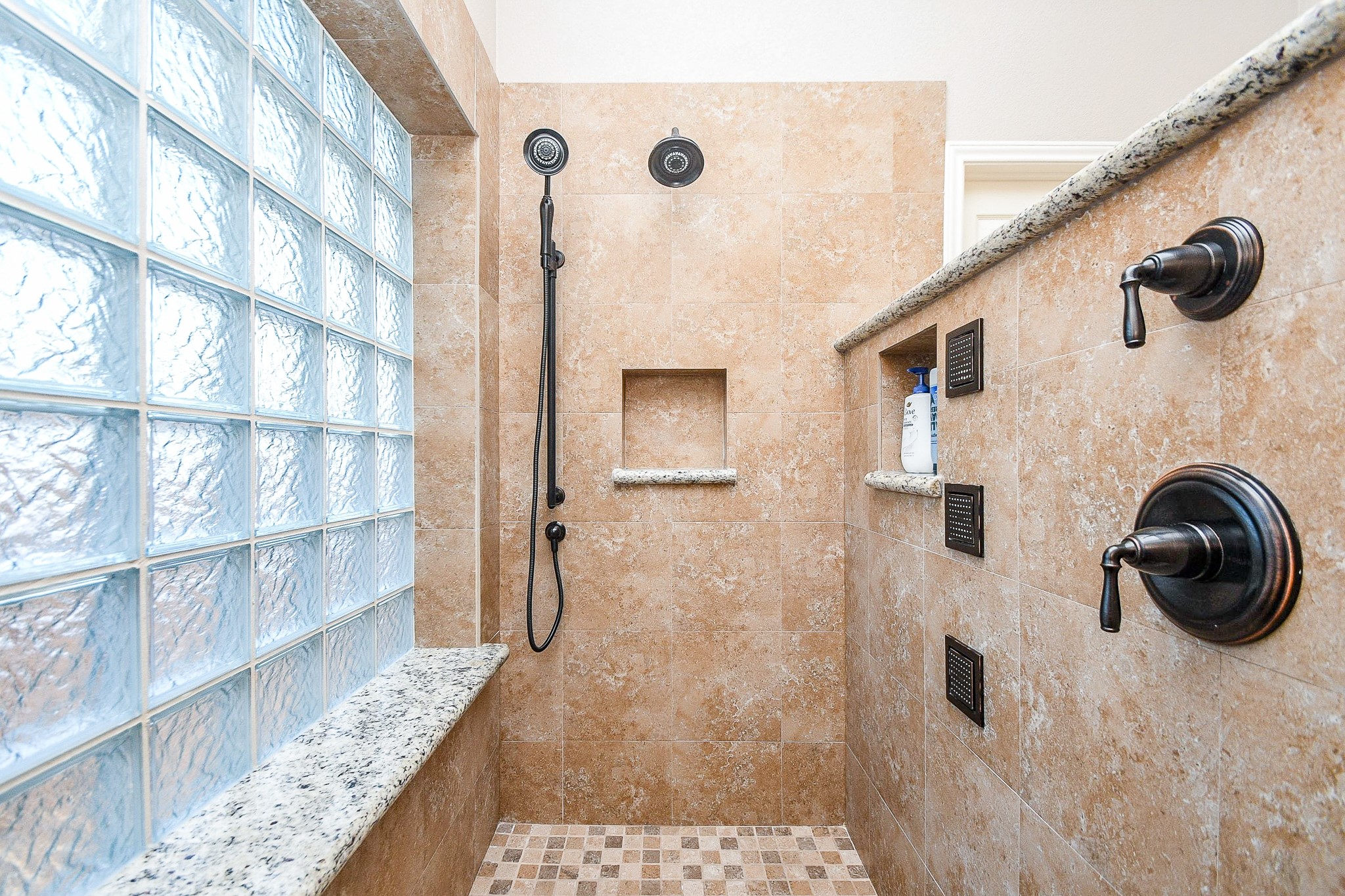 1703 Fall Ridge Circle Katy, TX 77494 - Photo 19 of 38 This spacious walk-in shower features dual shower heads, strategically placed fixtures, body sprays, and convenient built-in toiletry niches.