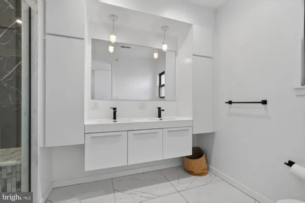 a bathroom with a sink a toilet and a mirror