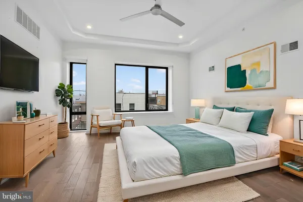 a bedroom with a large bed and a flat screen tv