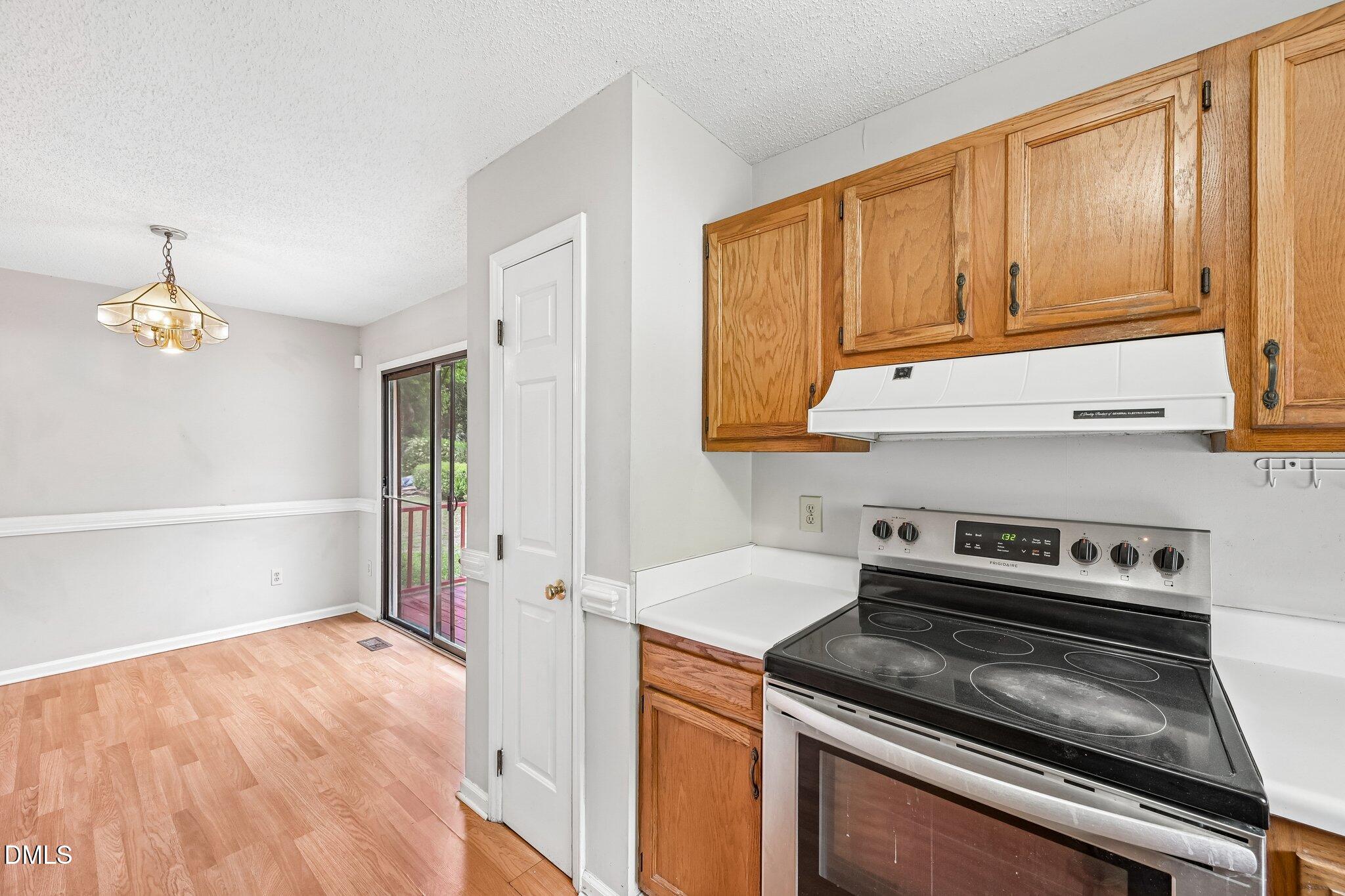2800 West Jameson Road Raleigh, NC 27604 - Photo 11 of 24 a kitchen with stainless steel appliances a stove a microwave and cabinets