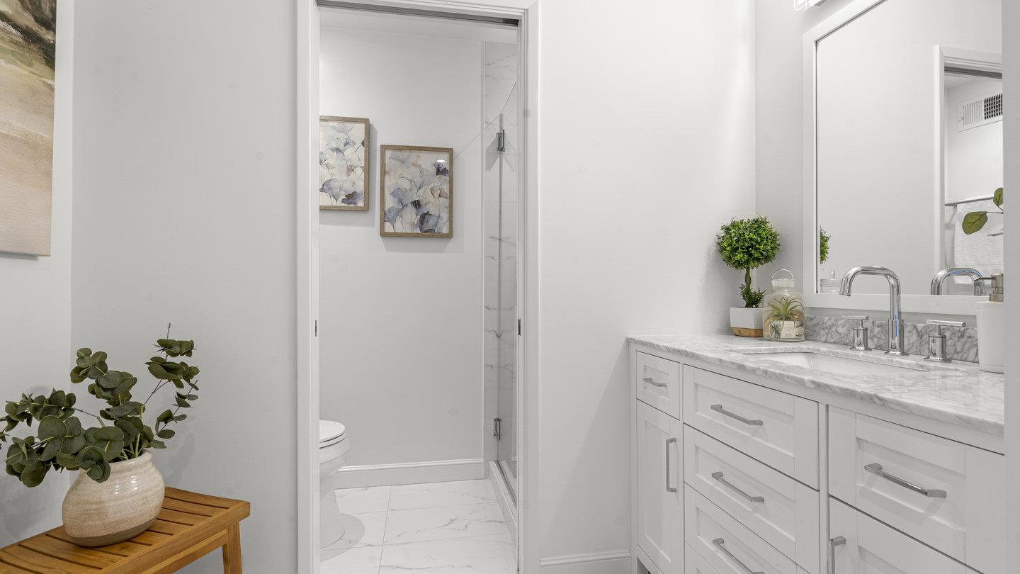 706 Celestial Lane Foster City, CA 94404 - Photo 21 of 36 a bathroom with a granite countertop sink a toilet and a mirror