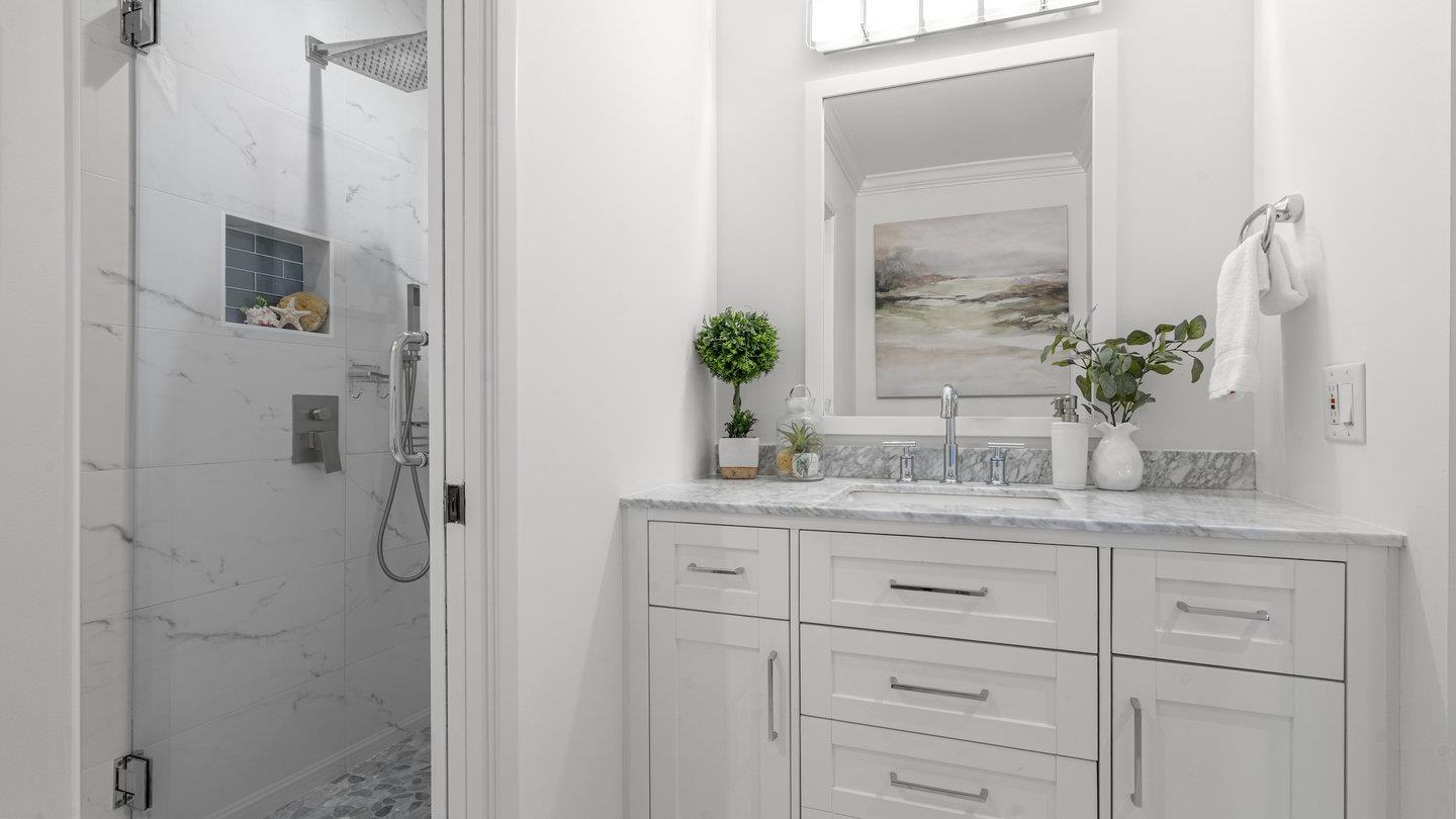706 Celestial Lane Foster City, CA 94404 - Photo 22 of 36 a bathroom with a granite countertop sink a potted plant and a mirror