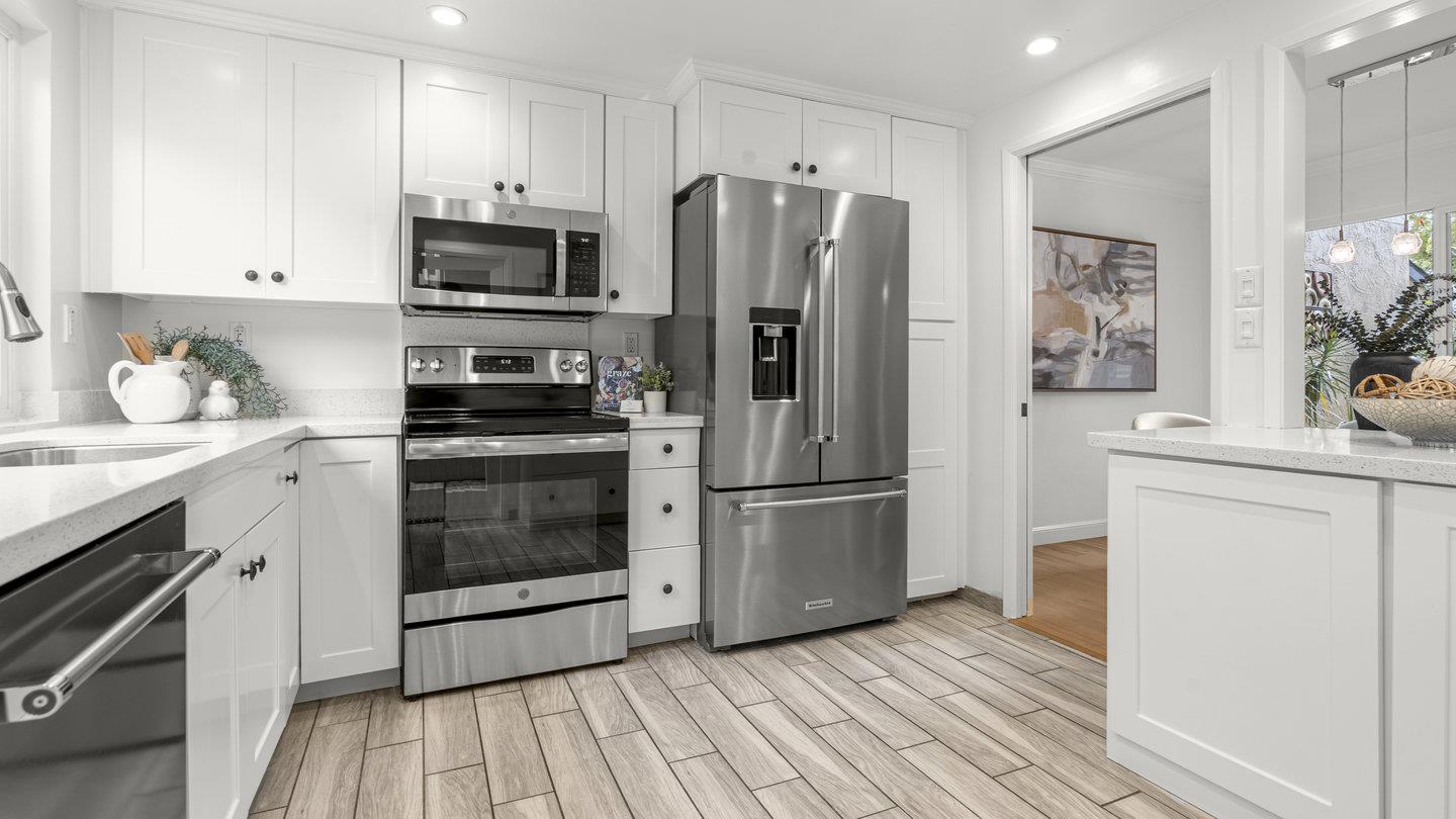 706 Celestial Lane Foster City, CA 94404 - Photo 6 of 36 a kitchen with a refrigerator cabinets and wooden floor