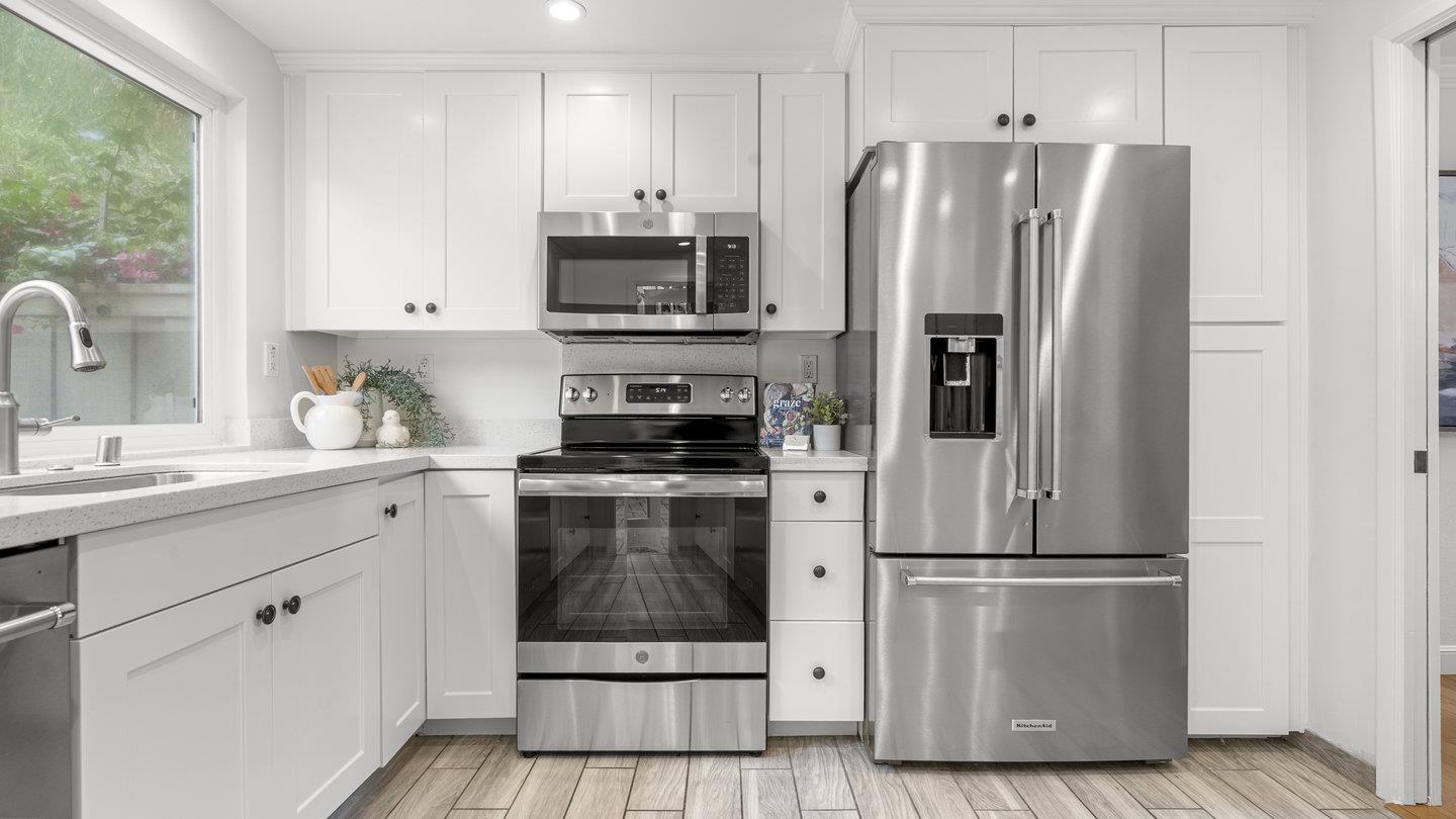 706 Celestial Lane Foster City, CA 94404 - Photo 7 of 36 a kitchen with stainless steel appliances a refrigerator stove and sink