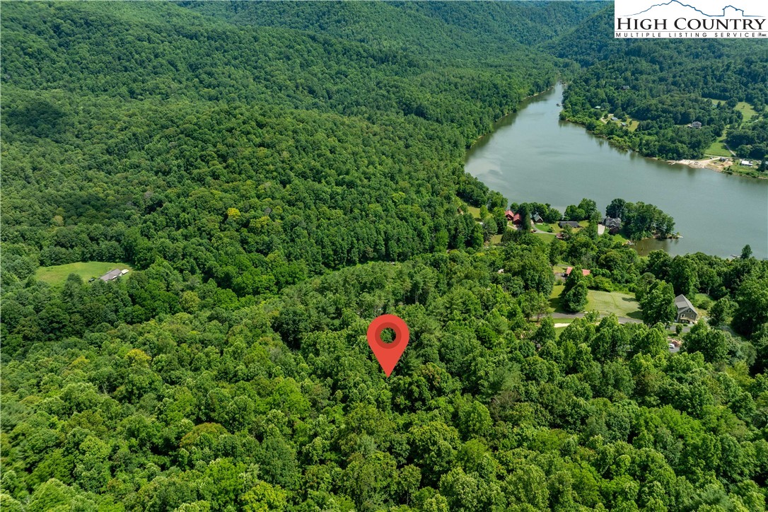 Lot 21 Lake Ridge Road Butler, TN 37640 - Photo 13 of 25 a backyard of a house with a yard and outdoor seating