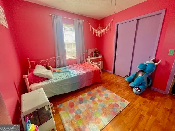 a bedroom with a bed and a mirror