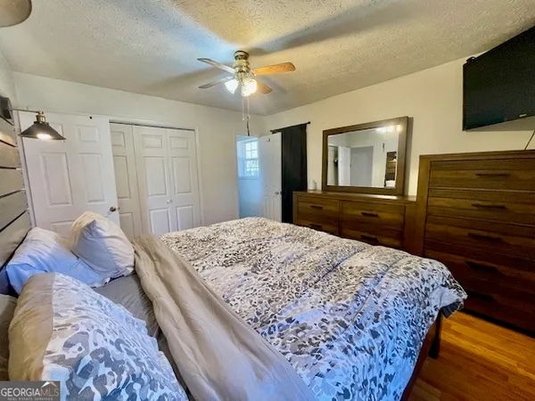 a bedroom with a bed and a flat screen tv