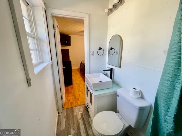 a white toilet sitting next to a bathroom sink