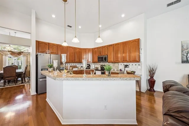a kitchen with stainless steel appliances granite countertop a stove and cabinets