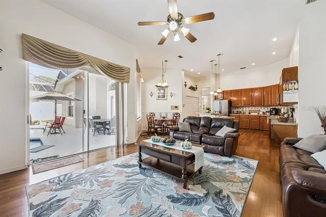a living room with furniture and wooden floor