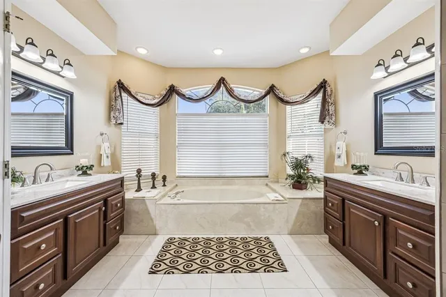 a bathroom with sink mirror and shower
