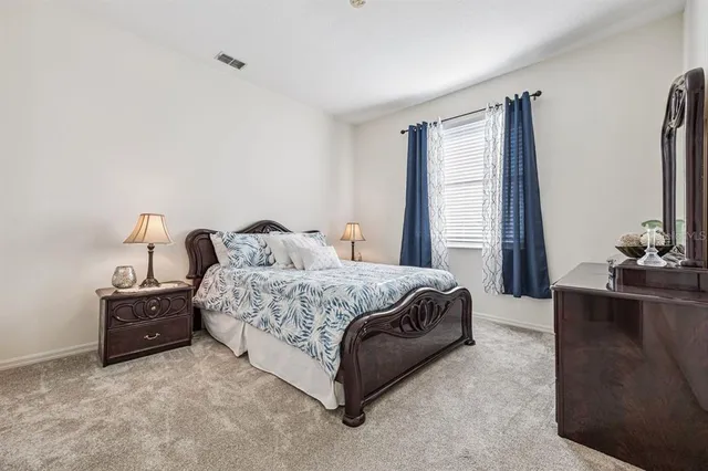 a bed room with a bed and a chandelier