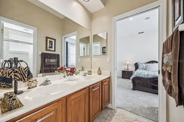 a bathroom with a sink a toilet a mirror and shower