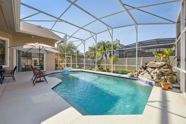 a view of a house with backyard and a tree