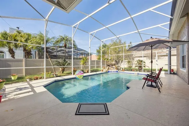 a view of a house with backyard and sitting area